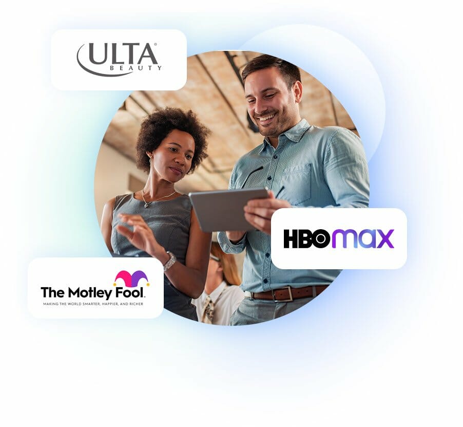 Man holiding a tablet standing next to a woman looking at the tablet with him. Our Partners, Affiliate Marketing Team