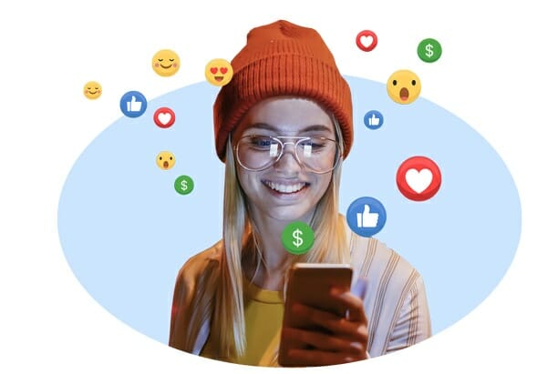 Woman wearing a hat smiling while looking at her phone w/ emojis floating around her head